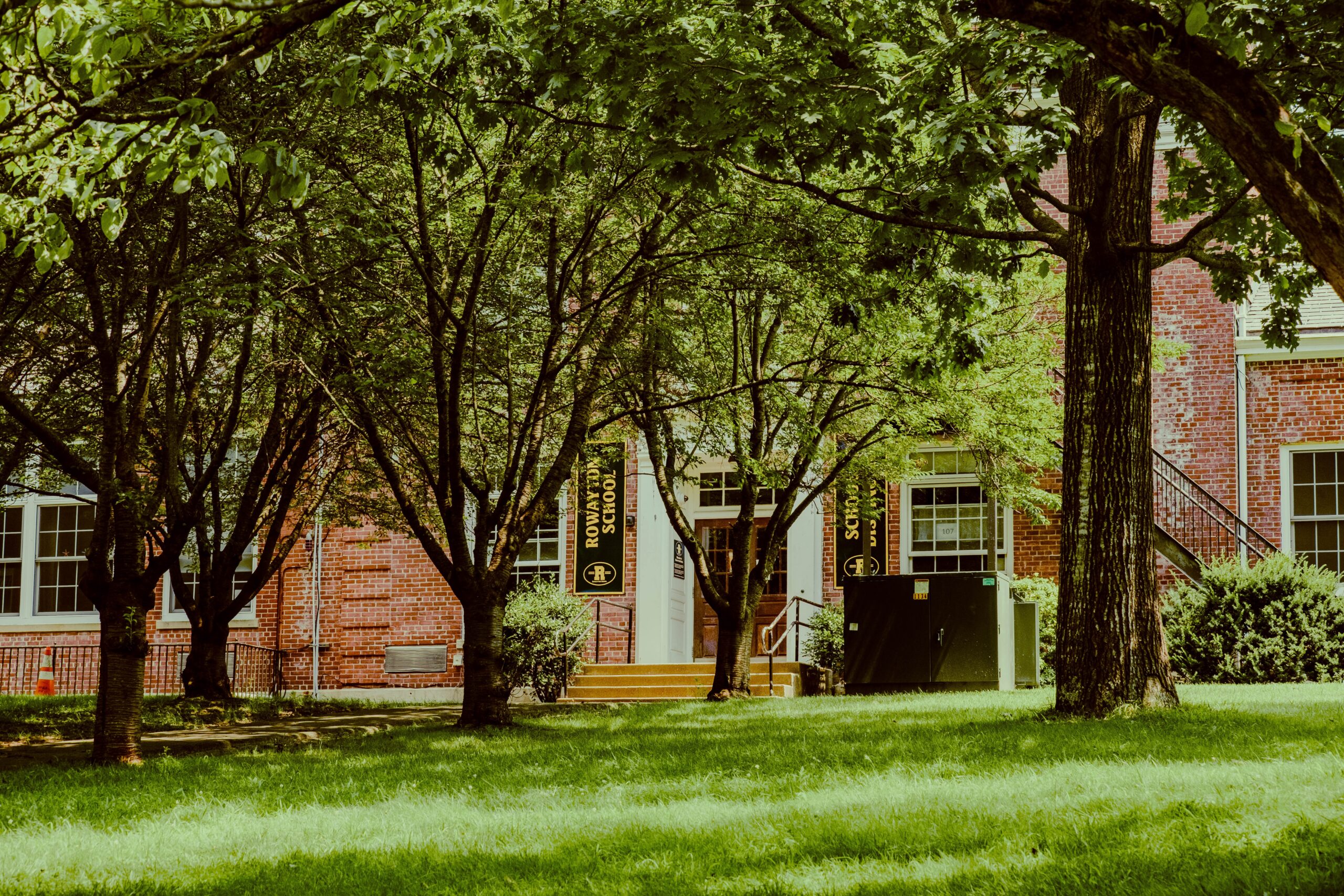 brown and white house near green trees during daytime