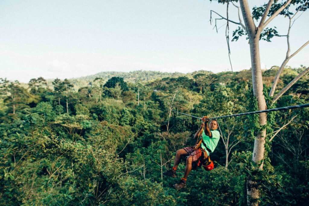 person sliding on zip line