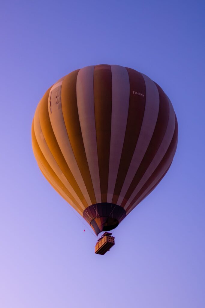 yellow and white hot air balloon in the sly during daytime