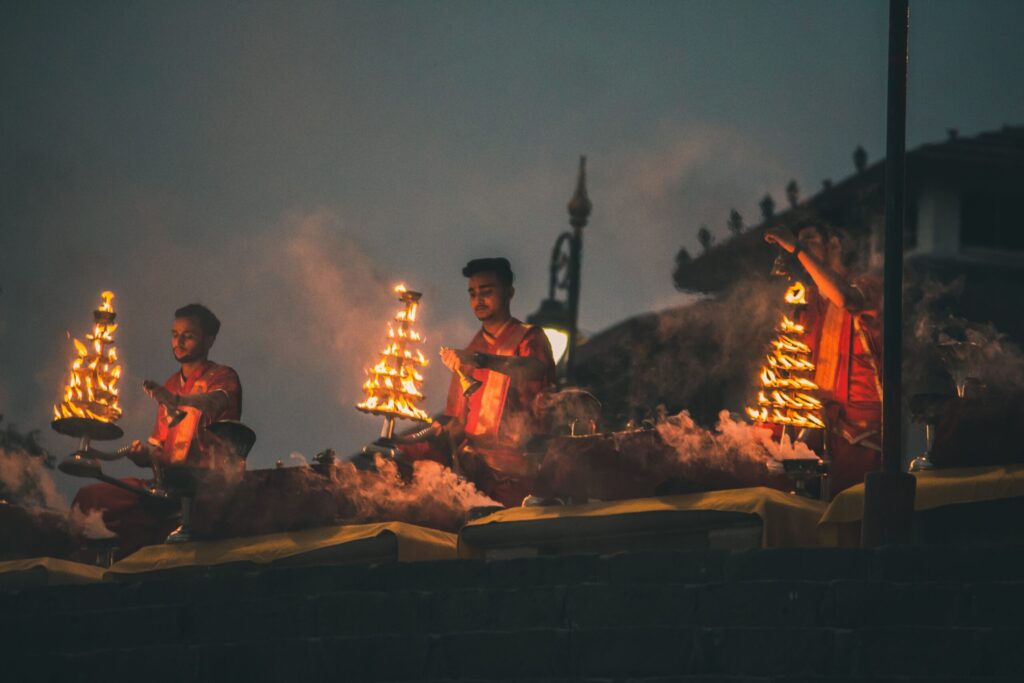 people sitting on brown wooden bench during night time