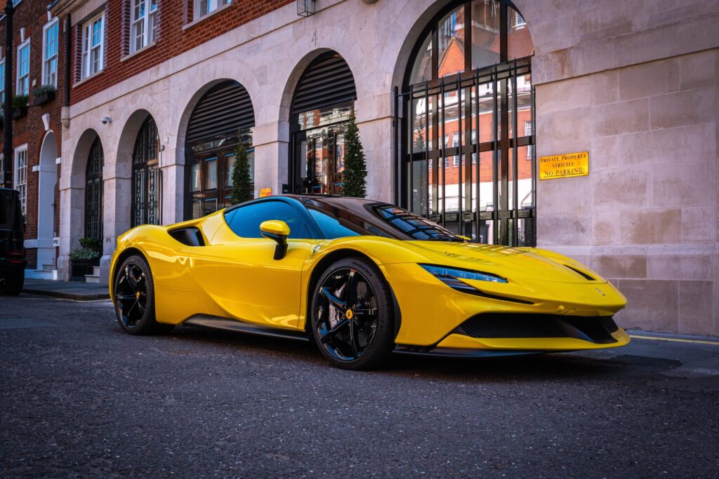 a yellow sports car parked in front of a building and Renting a Ferrari