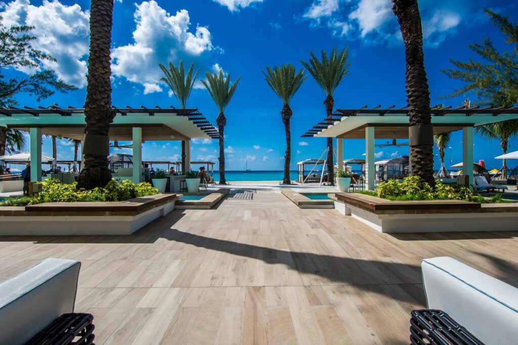 landscape photography of two pergolas near body of water. Weather In Grand Cayman Islands And The Best Time To Visit